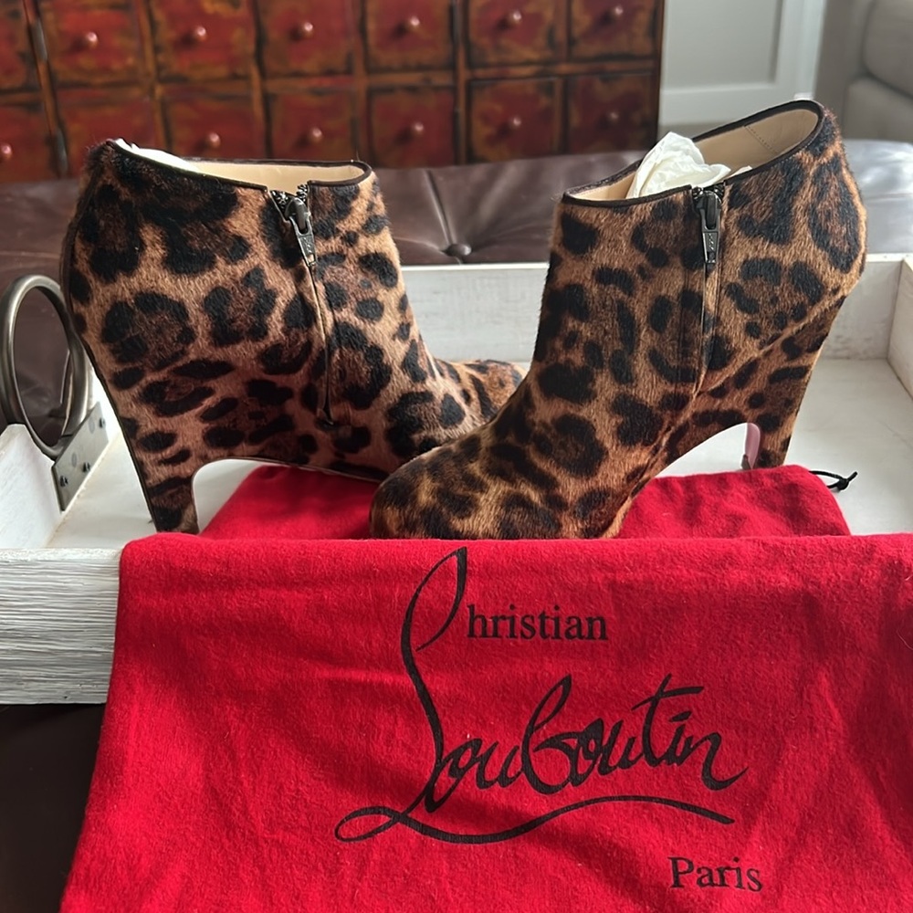 Christian Louboutin leopard ankle boots with red duster